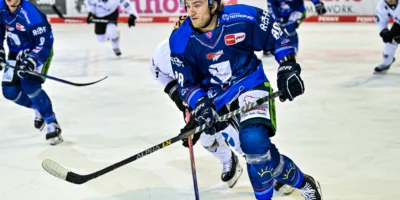 eishockey players on the ice are playing a game in blue and white jersey